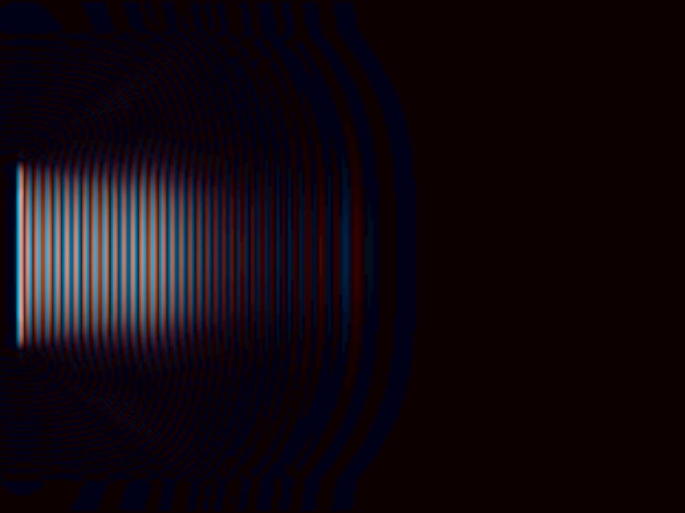A focused wave field in blue and orange, concentric wavefronts radiating from a source at the left edge into a dark background.