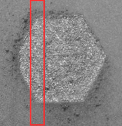 Camera image of the hexagonal part’s layer. The boxed region looks like the rest of the surface.